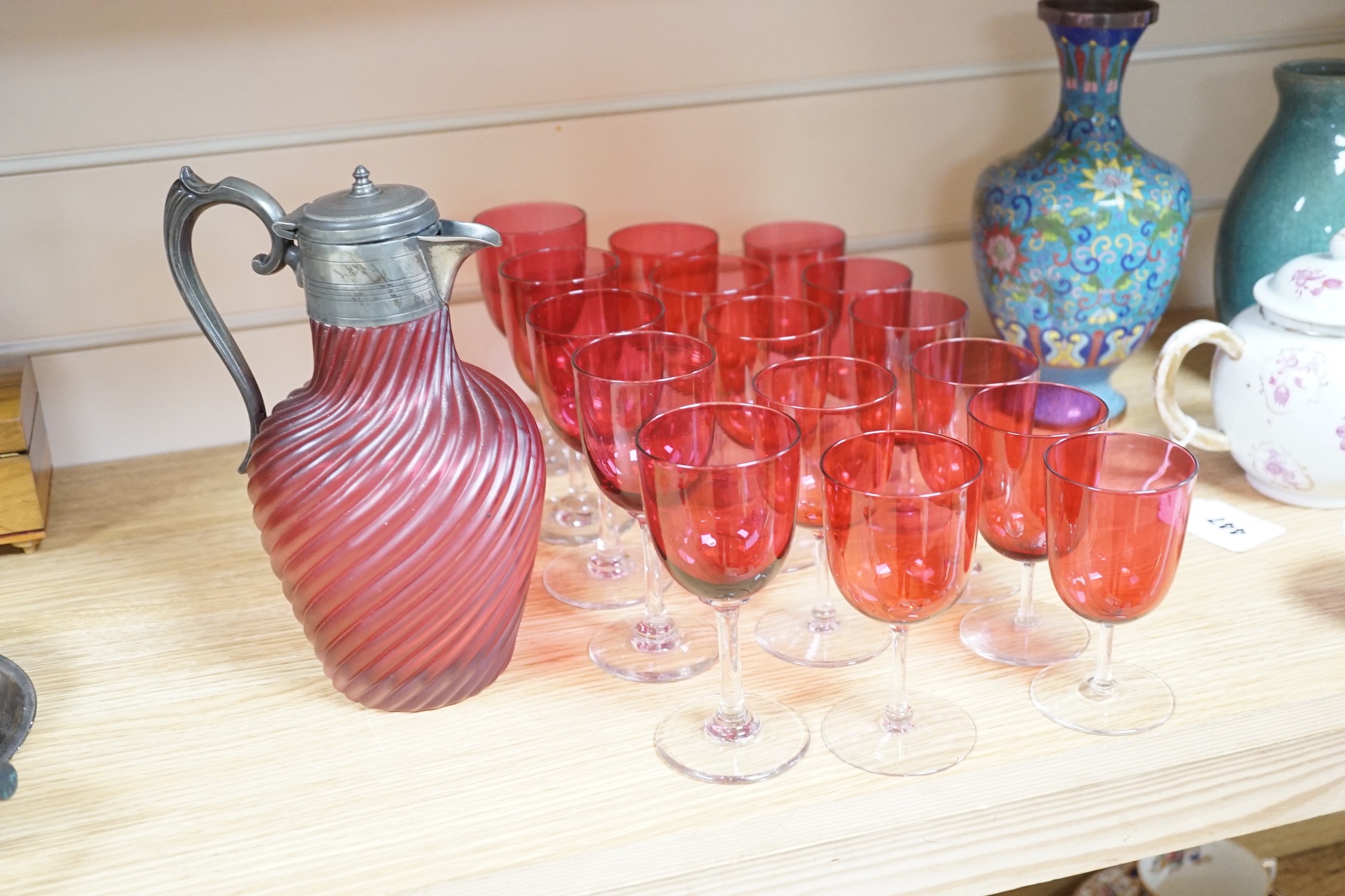 A Victorian wrythen moulded cranberry glass jug, 22cm high, and assorted wine glasses